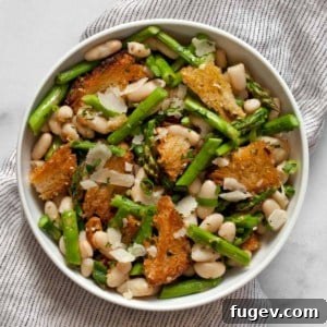 Close-up of the finished Asparagus Salad with Cannellini Beans and Toasted Bread, garnished with fresh herbs.