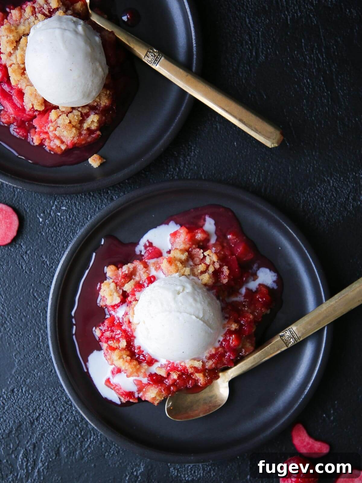 Homestyle Raspberry Rhubarb Crumble 2 Fresh raspberries scattered near a served portion of crisp.