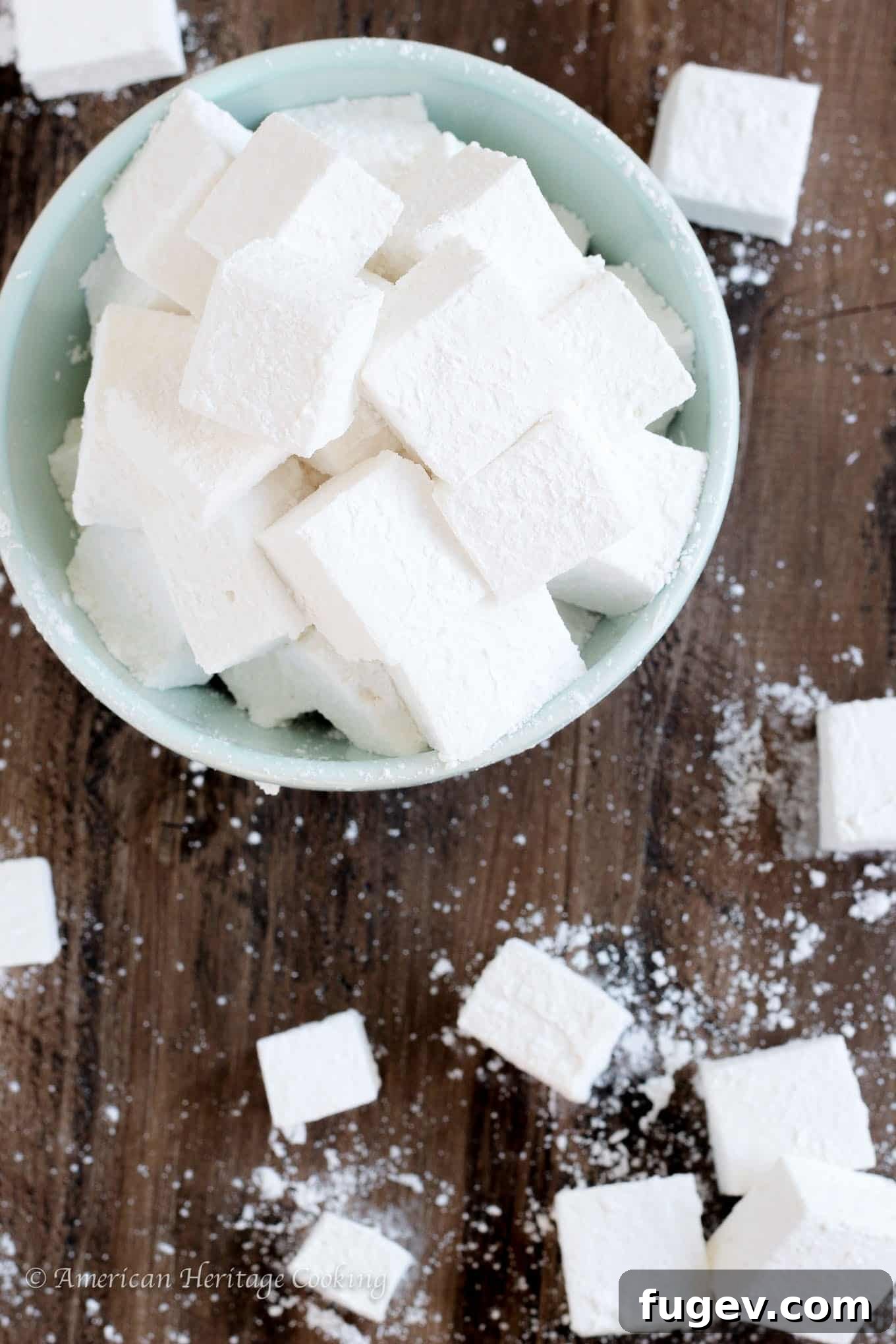 Fluffy Homemade Marshmallows 2 Close-up of fluffy homemade marshmallows in a bowl, dusted with powdered sugar, ready to be enjoyed with hot chocolate or s'mores.