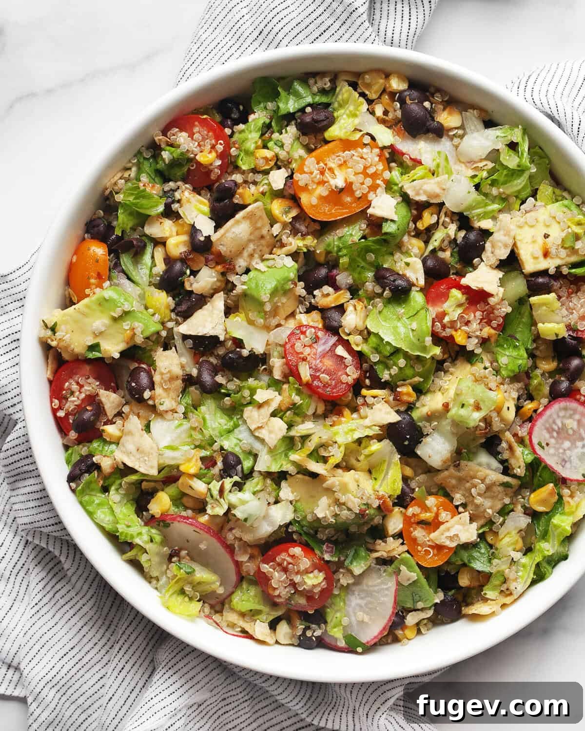 Quinoa Fiesta Bowl 2 A beautifully presented Quinoa Taco Salad in a bowl, showcasing fresh ingredients like corn, black beans, avocado, and tomatoes.