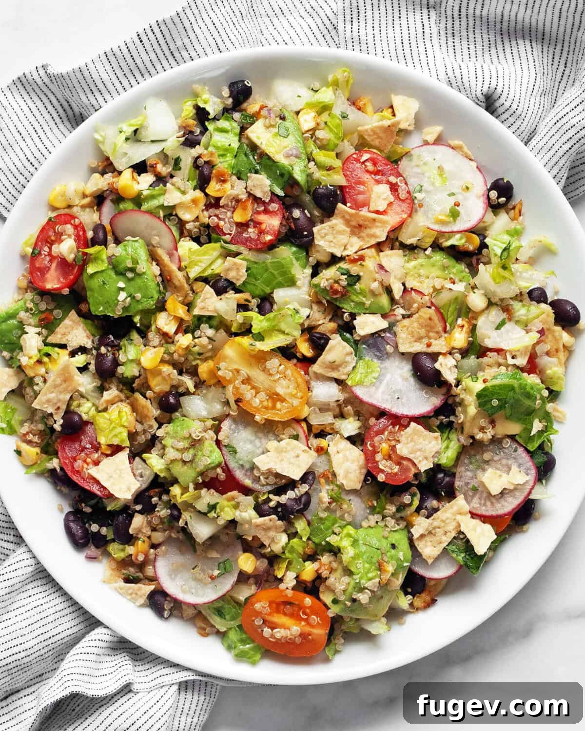 Quinoa Fiesta Bowl 7 A vibrant and healthy Quinoa Taco Salad elegantly plated, highlighting its fresh ingredients and inviting colors.