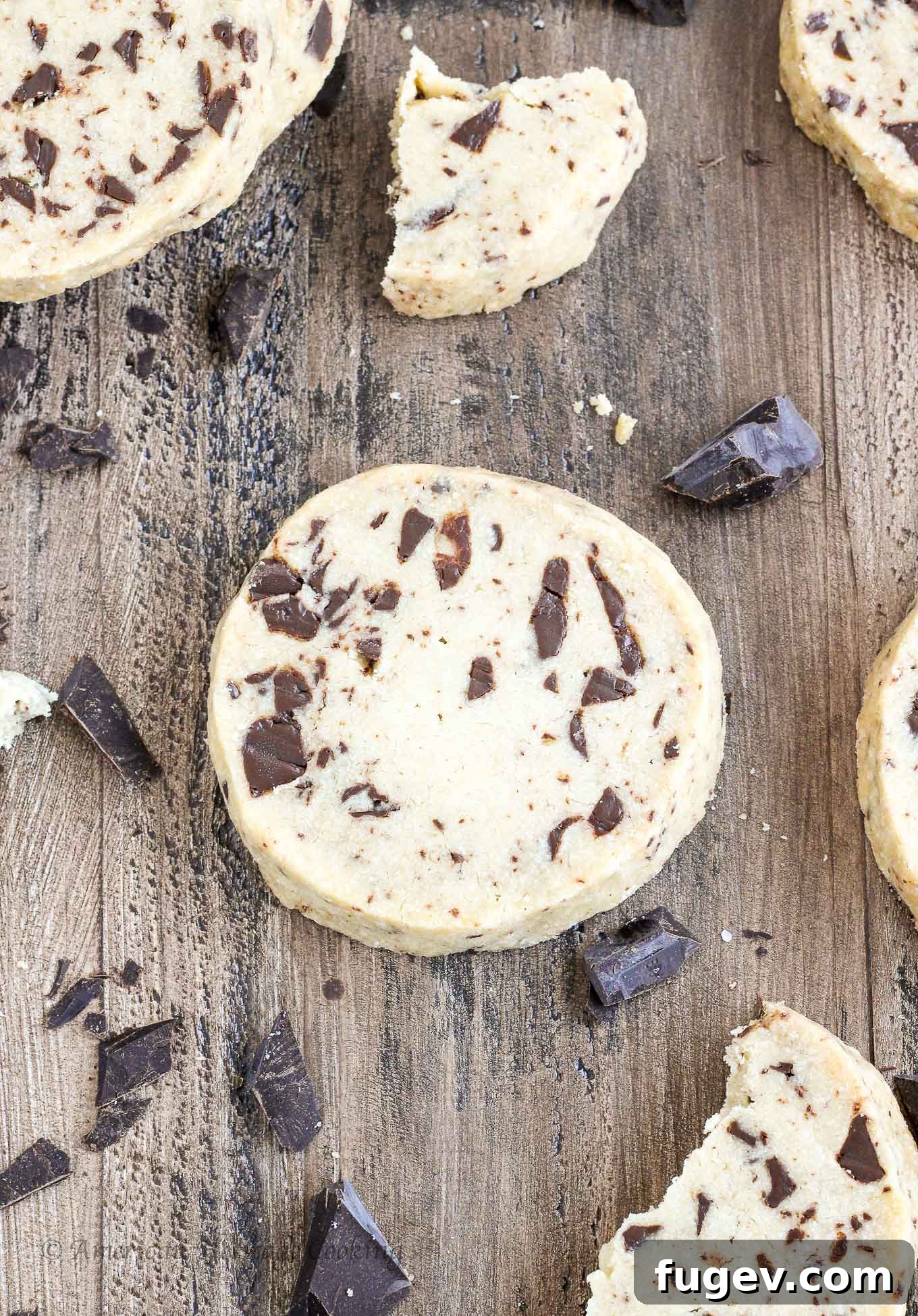 Buttery Chocolate Chip Shortbread Delights 2 Chocolate chip shortbread cookies on a wooden background, highlighting their soft texture and rich chocolate chunks.