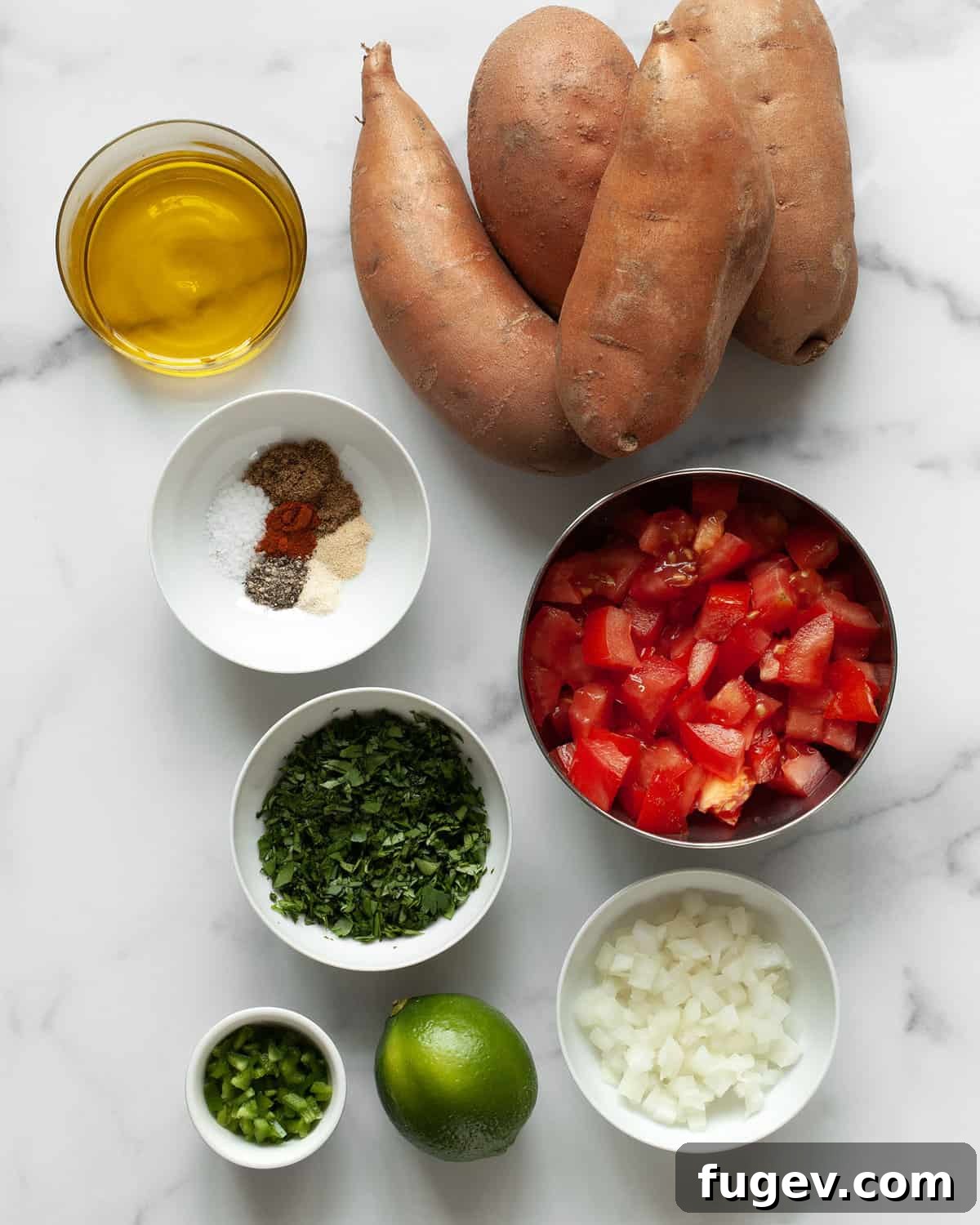 Effortlessly Delicious Grilled Sweet Potatoes 3 A collection of fresh ingredients for grilled sweet potatoes and pico de gallo, including sweet potatoes, spices, olive oil, tomatoes, onions, jalapeños, lime, and cilantro.