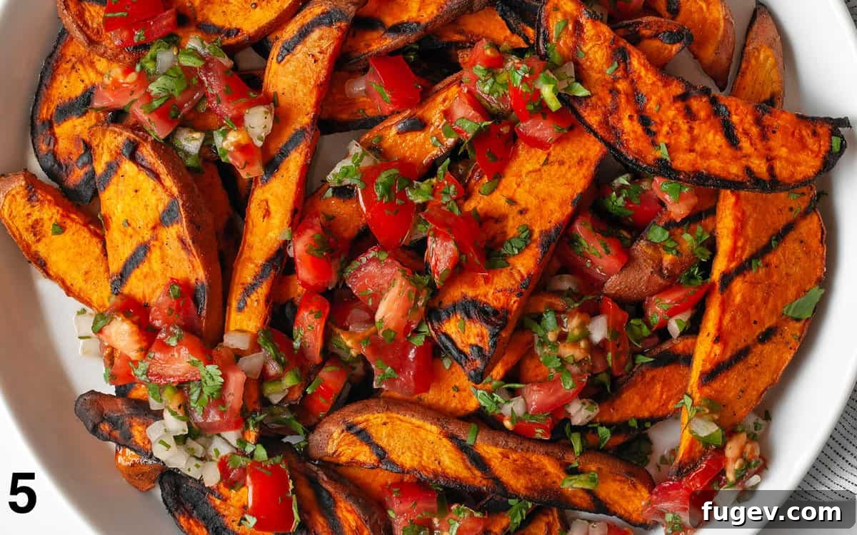 Effortlessly Delicious Grilled Sweet Potatoes 6 A close-up shot of grilled sweet potato slices beautifully arranged on a plate and richly topped with fresh, colorful pico de gallo.