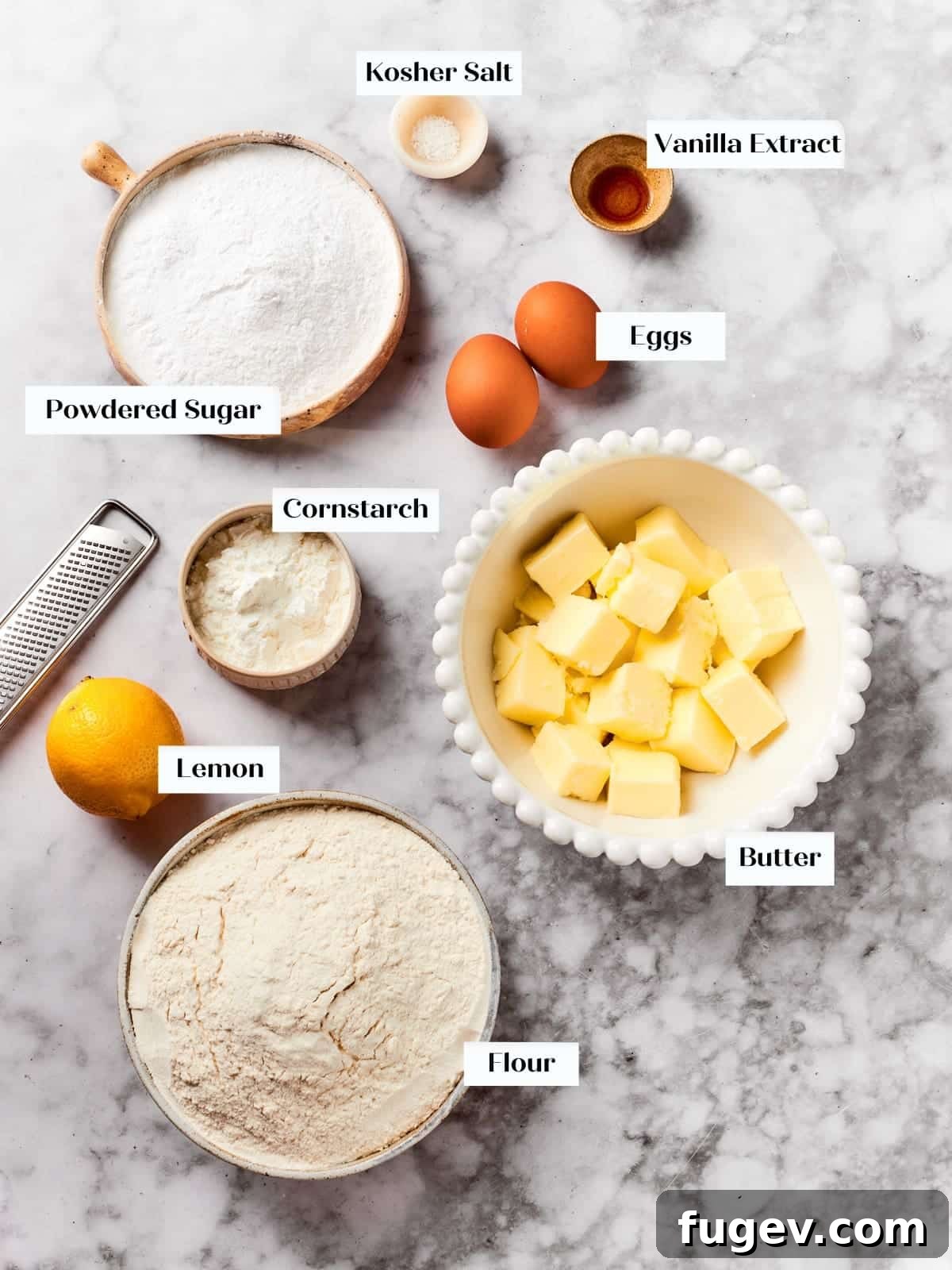 Easy Spritz Cookie Perfection 4 Ingredients for spritz cookies including butter, eggs, flour, and sugar arranged neatly on a kitchen counter.