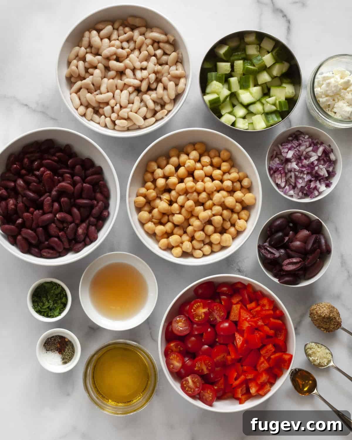 Vibrant Mediterranean Bean Medley 3 Individual ingredients for the Mediterranean bean salad including various beans, colorful vegetables, fresh herbs, feta cheese, and olive oil.
