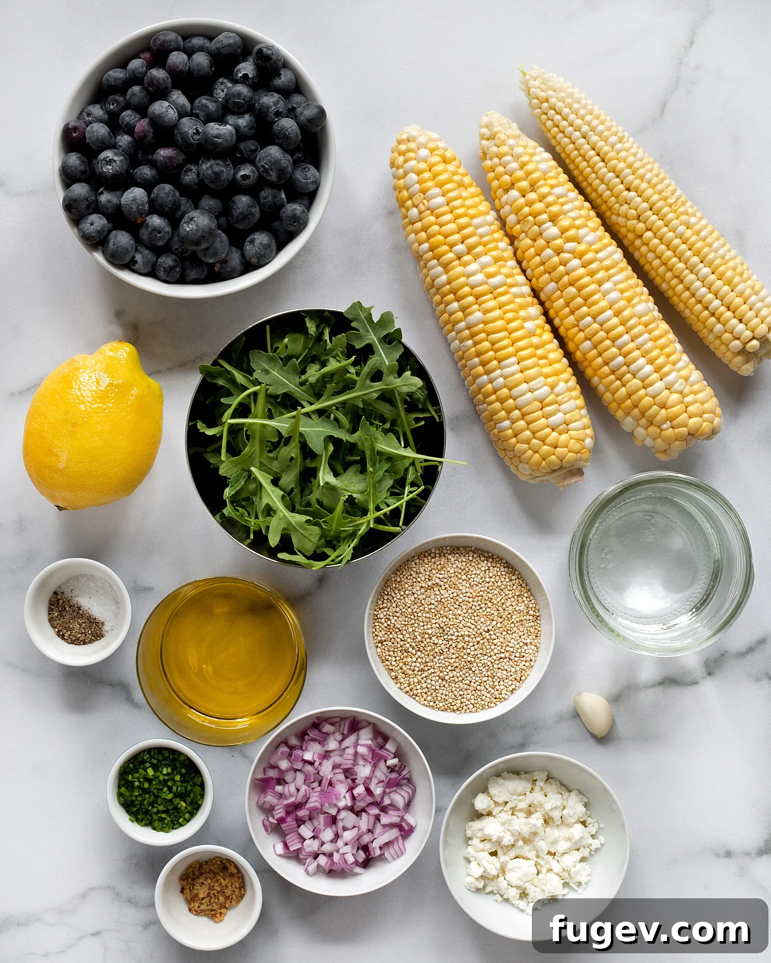 Golden Corn Blueberry Medley 3 A flat lay photograph showcasing the fresh ingredients for the blueberry corn salad: ripe blueberries, grilled corn kernels, vibrant arugula, cooked quinoa, and crumbled feta cheese.