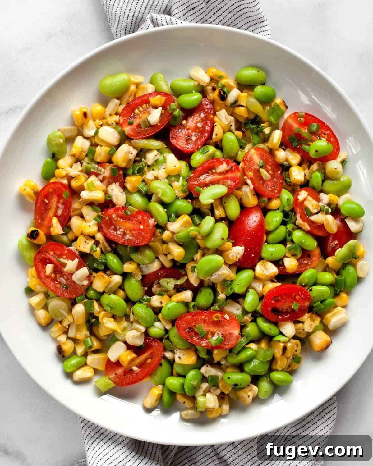 Sunshine Succotash with Edamame and Corn 2 Grilled corn succotash on a plate, showcasing its vibrant colors and fresh ingredients.