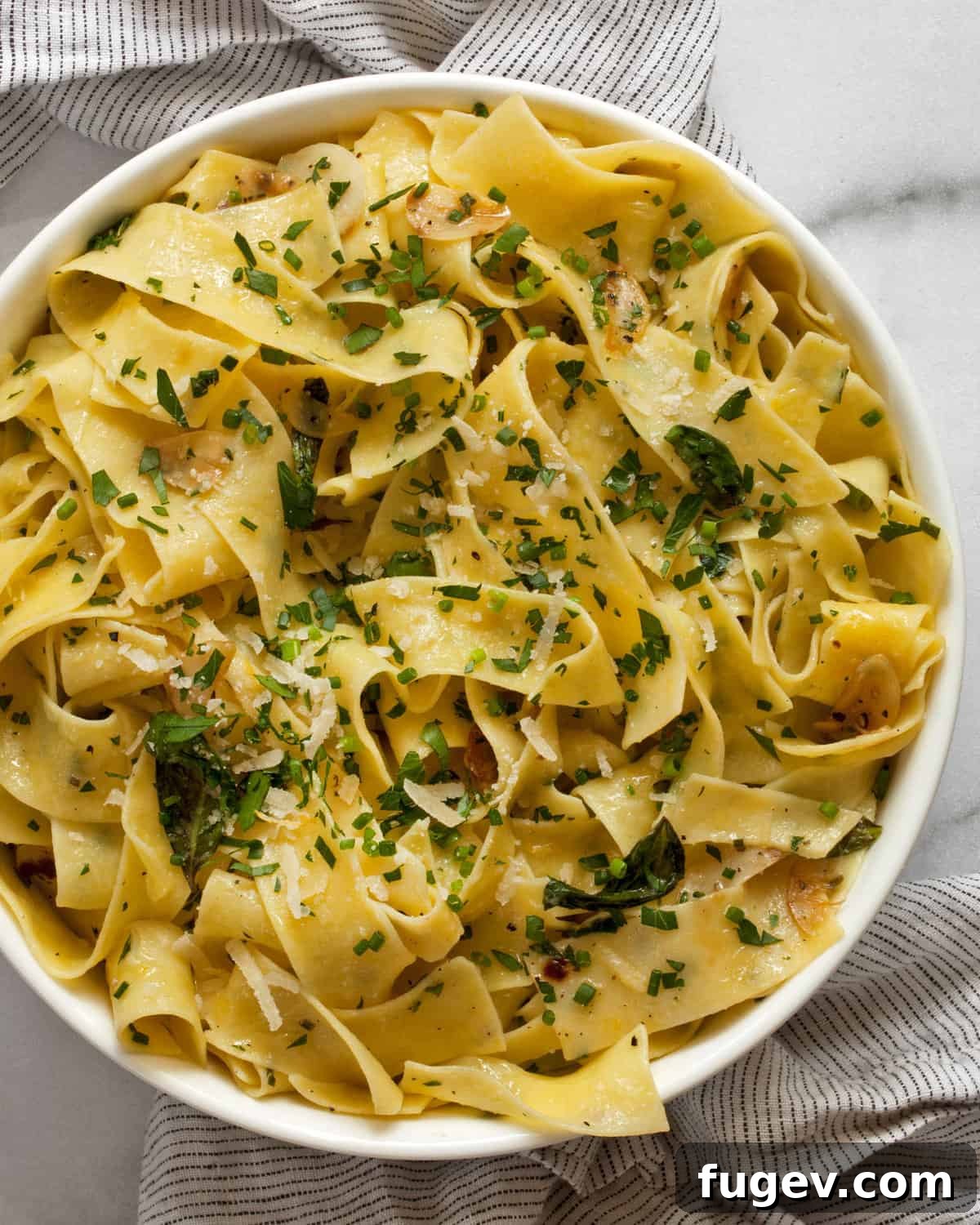 Vibrant Fresh Herb Pappardelle 2 A beautiful bowl of fresh herb pappardelle pasta, garnished with fresh herbs and a sprinkle of cheese.
