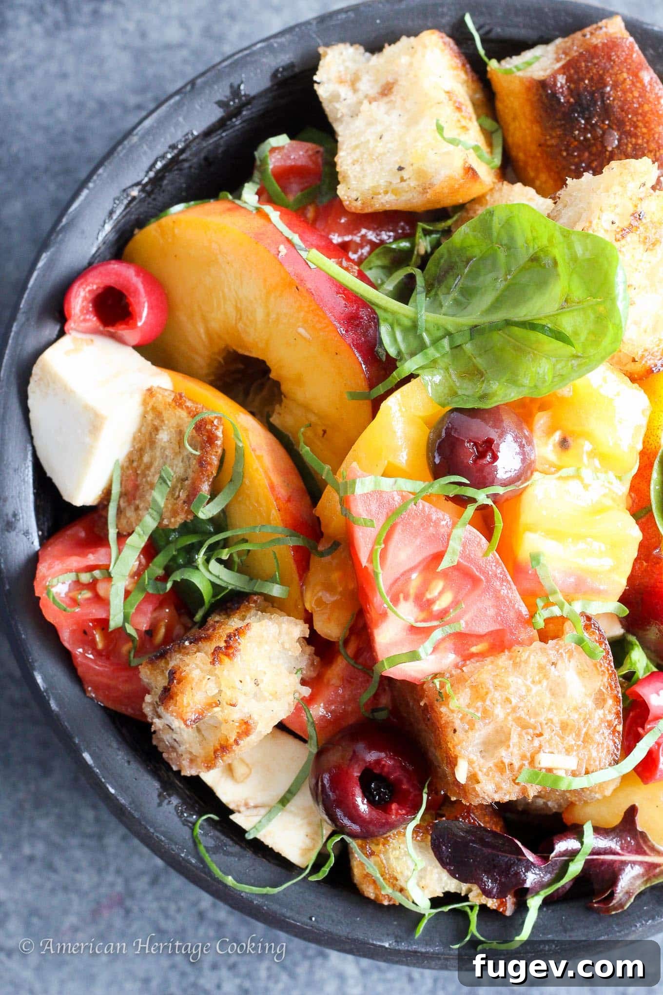Orchard Fresh Caprese Panzanella 2 Vibrant Stone Fruit Caprese Panzanella Salad in a rustic black wooden bowl, showcasing juicy peaches, ripe heirloom tomatoes, creamy mozzarella balls, and fresh basil leaves.