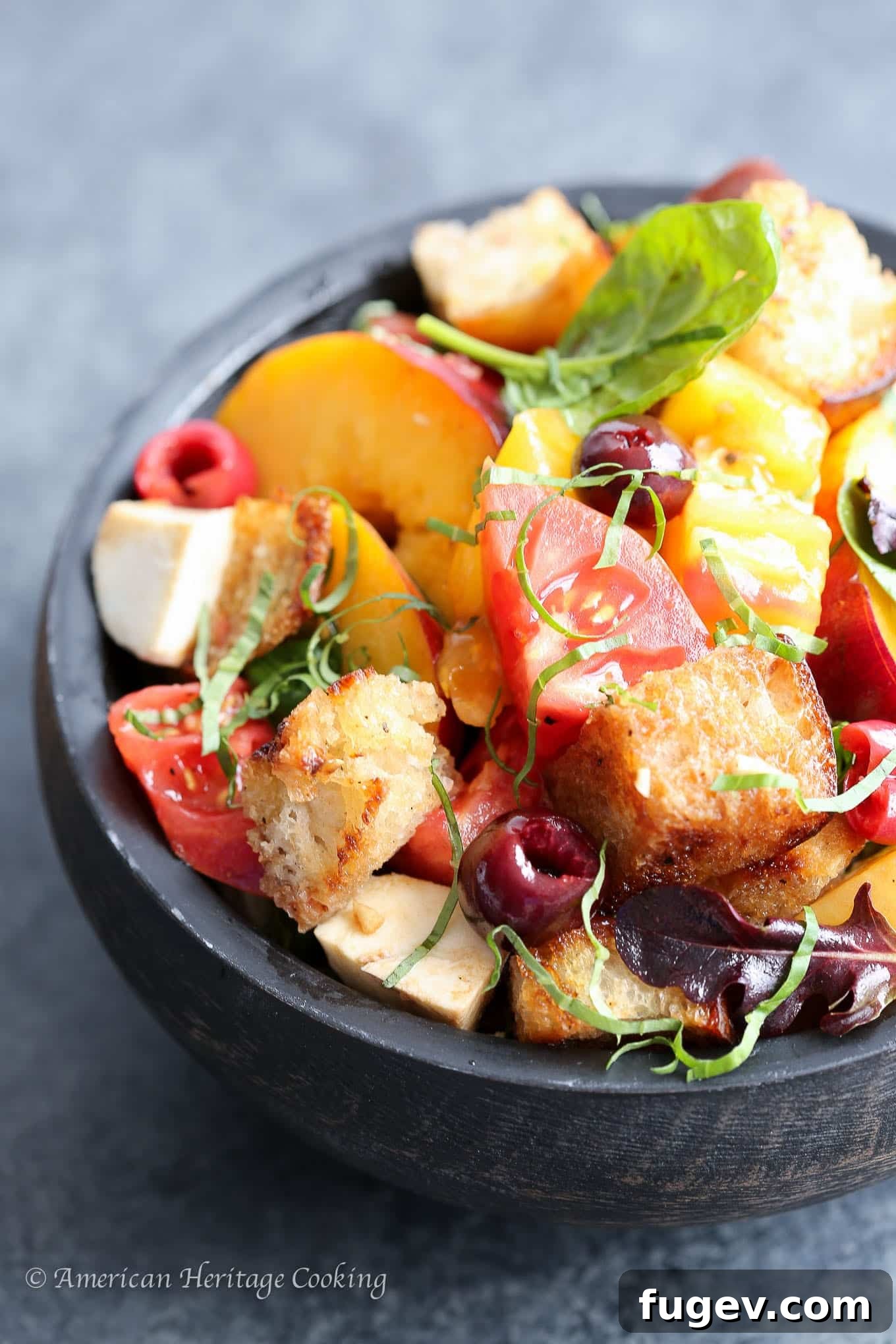 Orchard Fresh Caprese Panzanella 3 Close-up detailed shot of Stone Fruit Caprese Panzanella Salad, highlighting colorful heirloom tomatoes, creamy mozzarella, sliced peaches, and golden croutons.