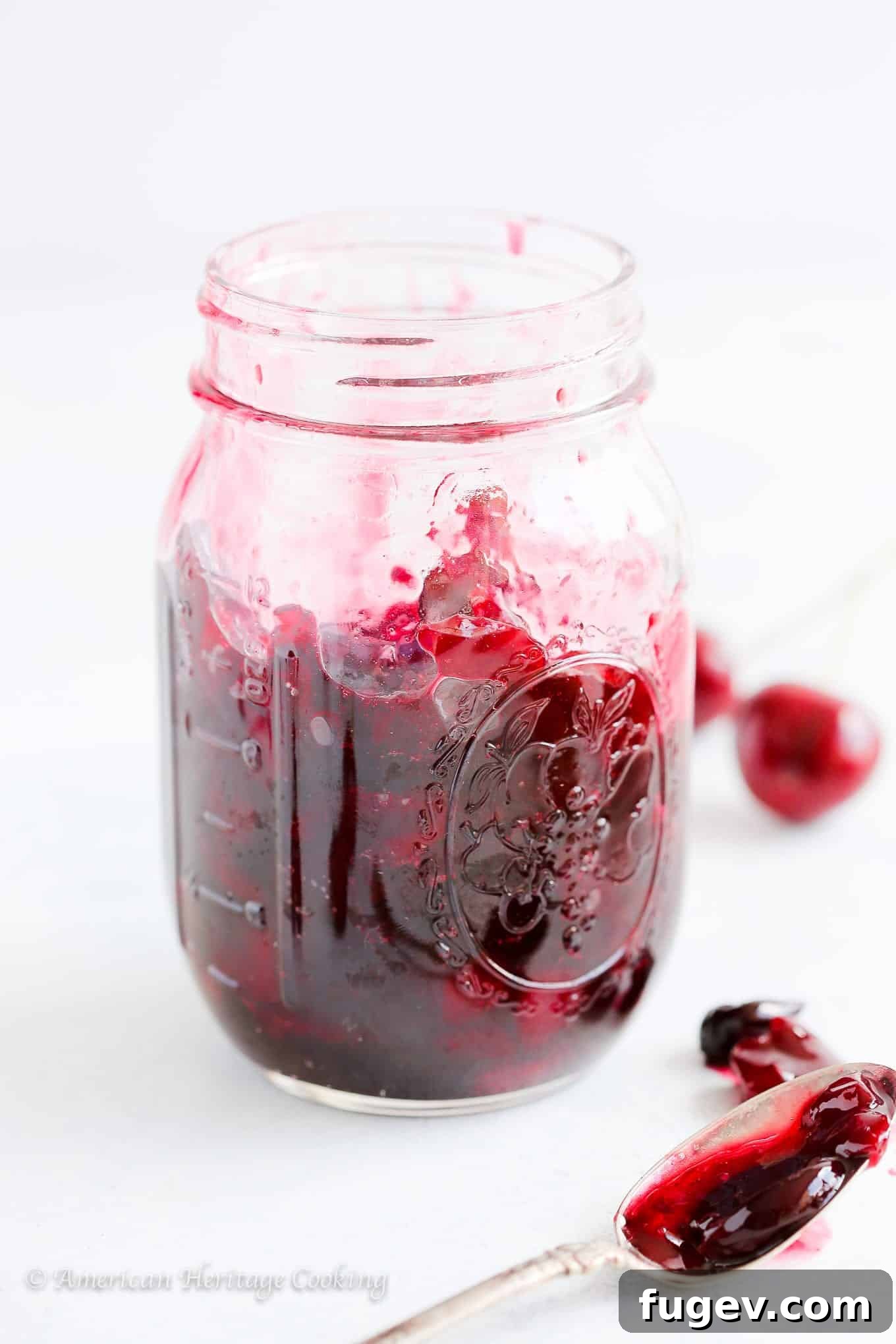 Simply Divine Cherry Jam 2 A beautiful jar of homemade cherry preserves, showcasing the vibrant red color and rich texture. Perfect for enjoying summer's bounty all year long, especially spread on black pepper honey ricotta toast for an easy snack or breakfast.