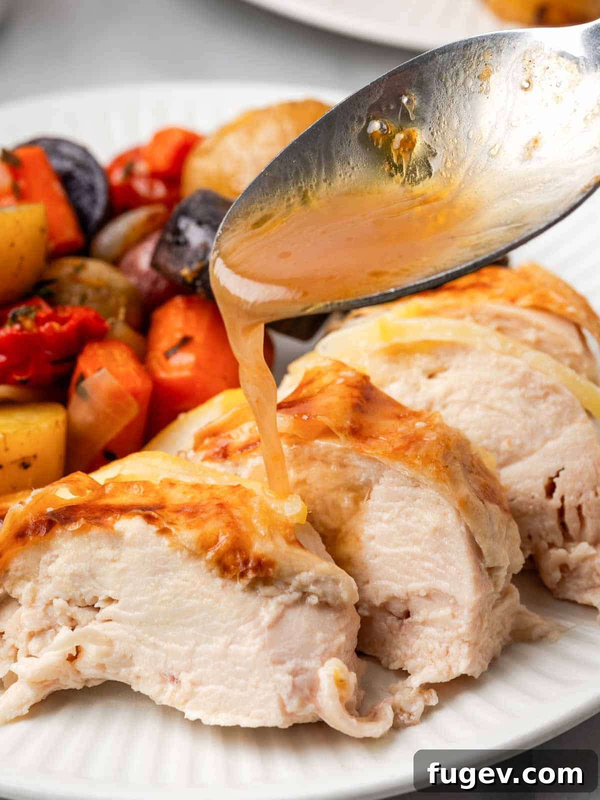 Zesty Lemon Roasted Chicken 2 adding pan sauce to sliced chicken.