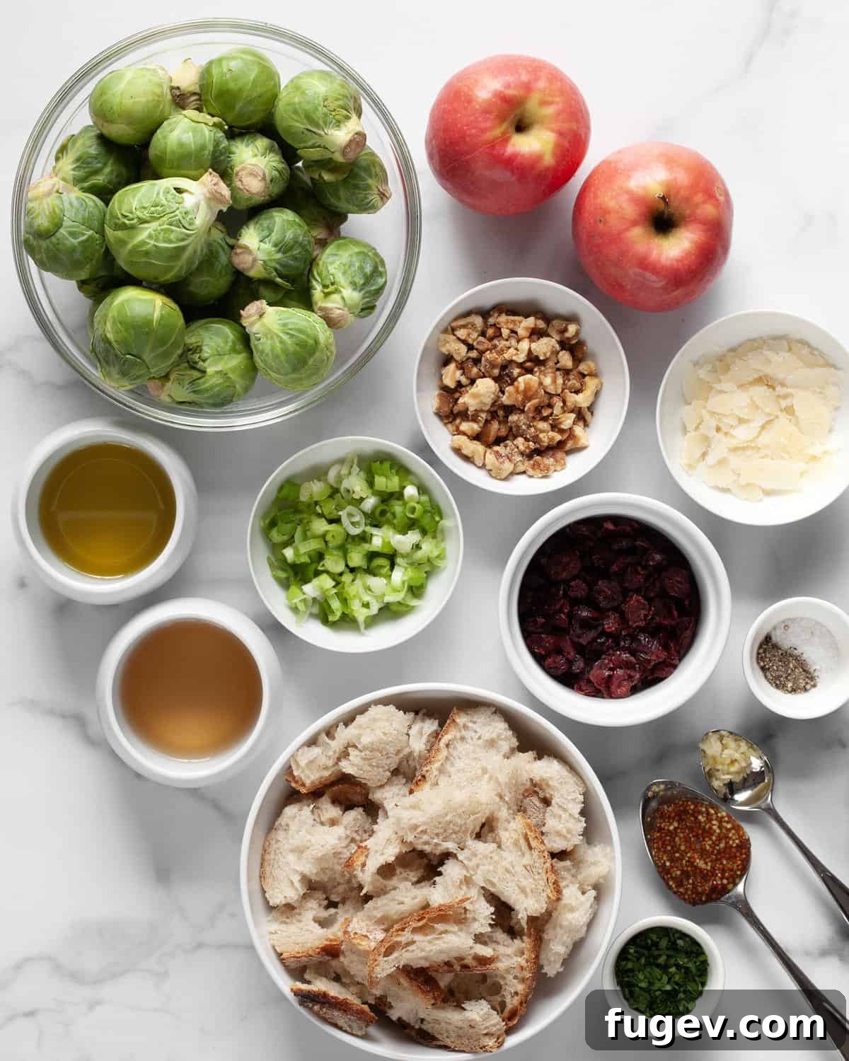 Shaved Brussels Sprout Salad with Crisp Apples and Toasted Walnuts 3 A beautiful flat lay photograph showcasing all the fresh and wholesome ingredients needed for the Brussels sprout apple salad, including crisp green Brussels sprouts, vibrant red apples, crunchy walnuts, fresh scallions, rustic sourdough bread, sweet dried cranberries, grated Parmesan cheese, olive oil, white wine vinegar, whole grain mustard, and a clove of garlic.