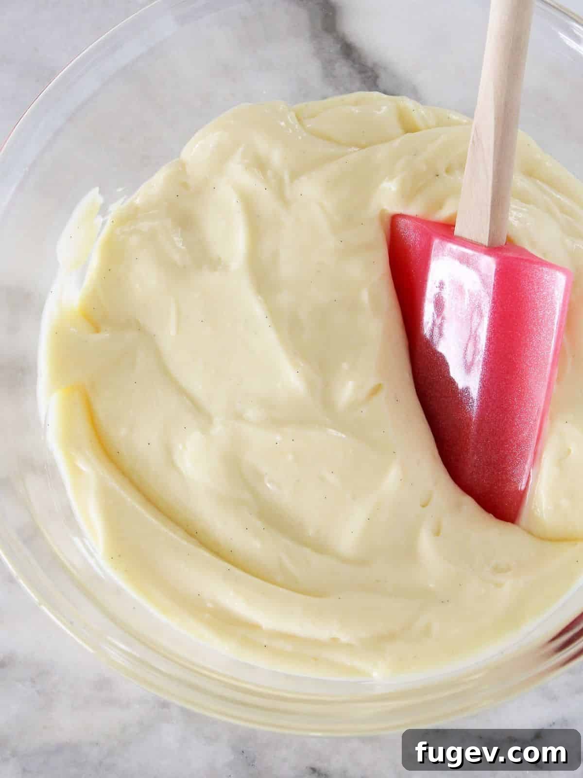 Perfect Homemade Pastry Cream 2 Pastry cream on a marble counter, showcasing its smooth, rich texture.