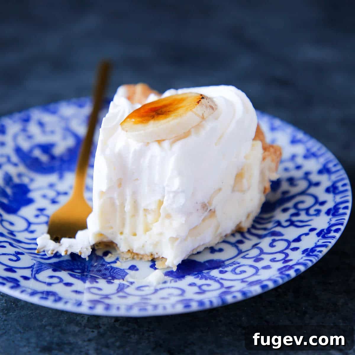 Perfect Homemade Pastry Cream 3 A slice of Banana Cream Pie, layered with luscious pastry cream, on a blue plate.
