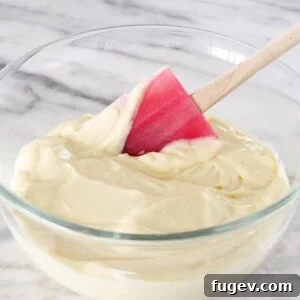 Pastry cream with a red silicone spatula, ready to be used.