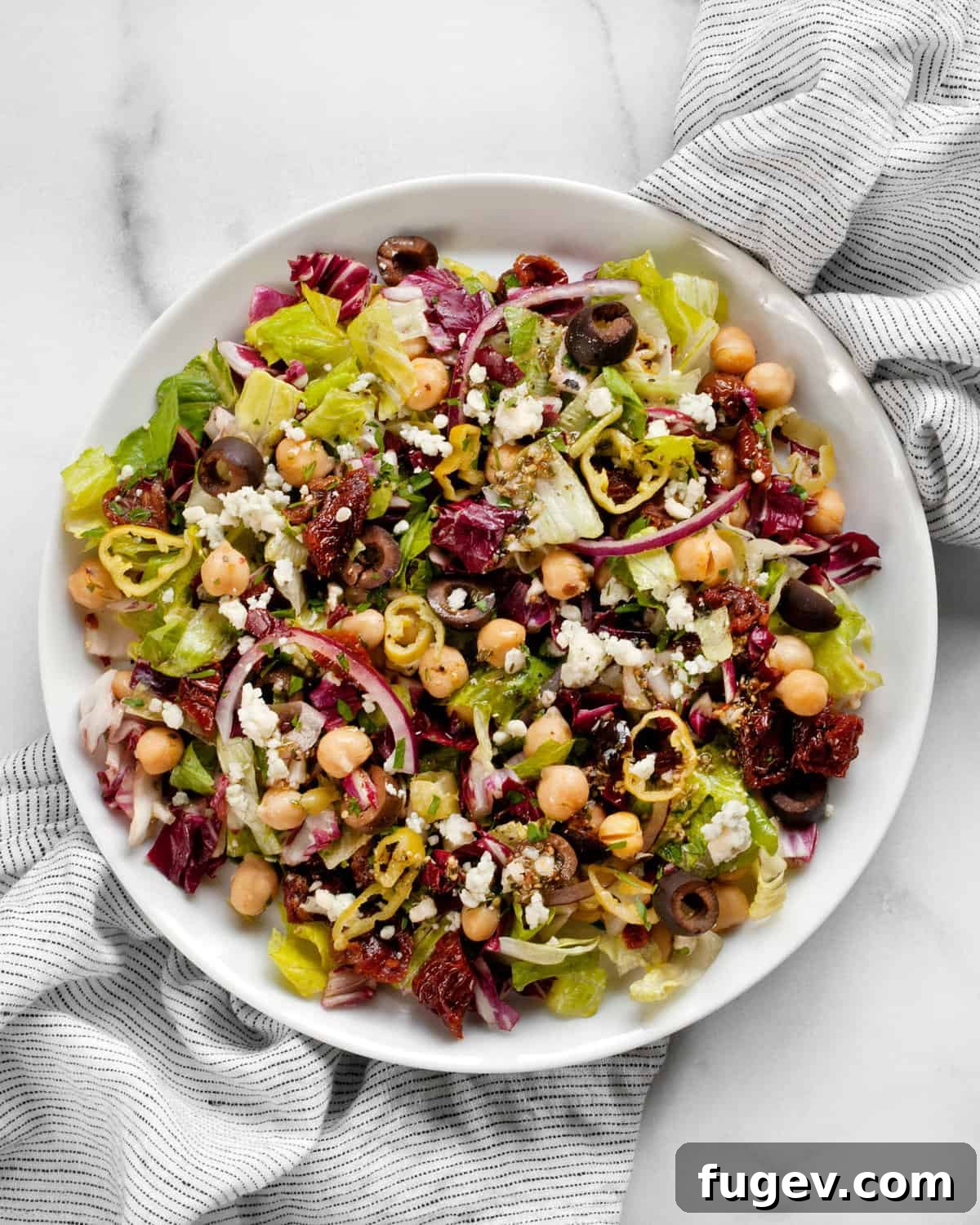Vibrant Italian Chopped Salad 6 Chopped salad with chickpeas, romaine and radicchio on a plate, ready to be enjoyed.