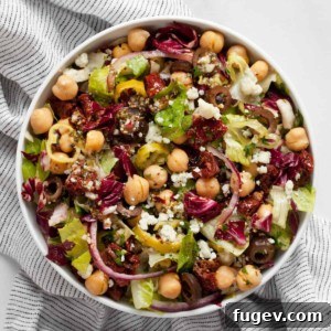 Vibrant Italian Chopped Salad 7 Salad with romaine, radicchio, chickpeas and tomatoes in a bowl.