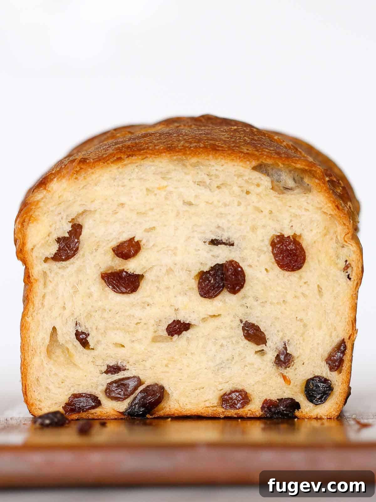 Artisan Sourdough Raisin Loaf 2 Sliced sourdough raisin bread loaf showcasing its soft interior and abundant raisins against a clean white background.