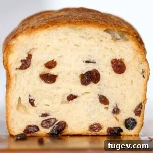 sliced sourdough raisin bread loaf with lots of raisins throughout.