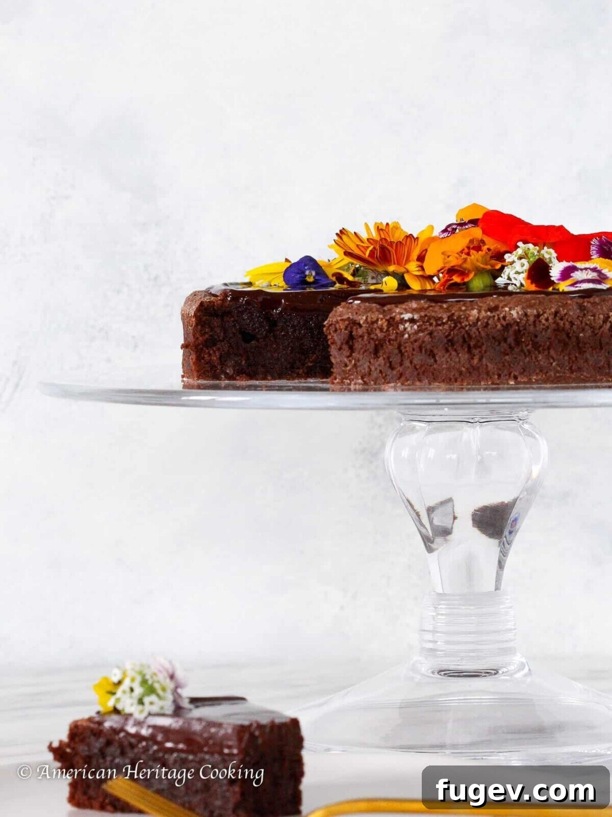 Decadent Flourless Chocolate Torte 2 Flourless Chocolate Torte on a clear cake stand for Valentine's Day Desserts.