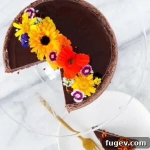 Hazelnut Flourless Chocolate Cake sliced with edible flowers.