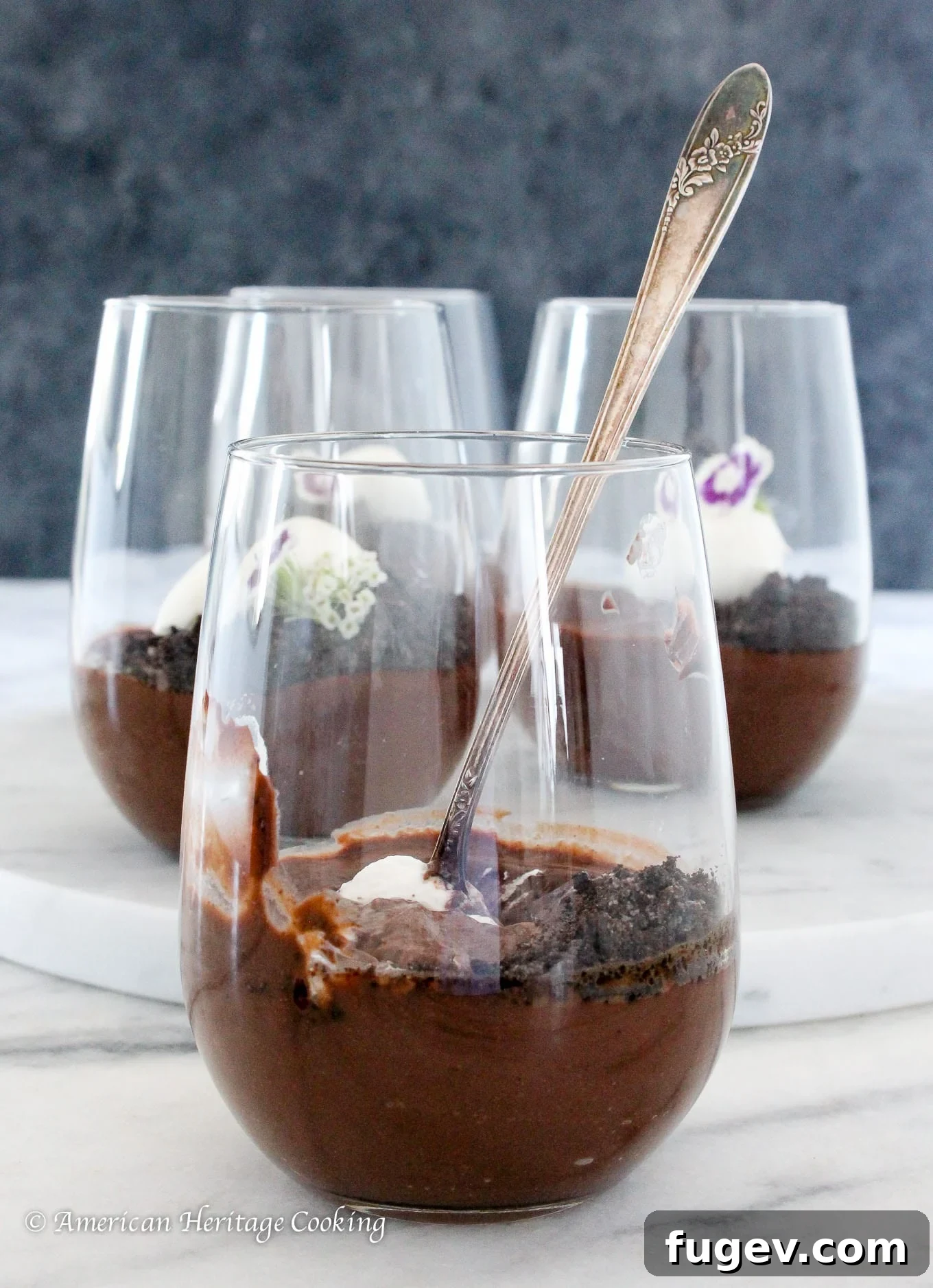 Decadent Homemade Chocolate Pudding 3 Three elegantly presented clear cups of dark chocolate pudding, garnished and ready for enjoyment.