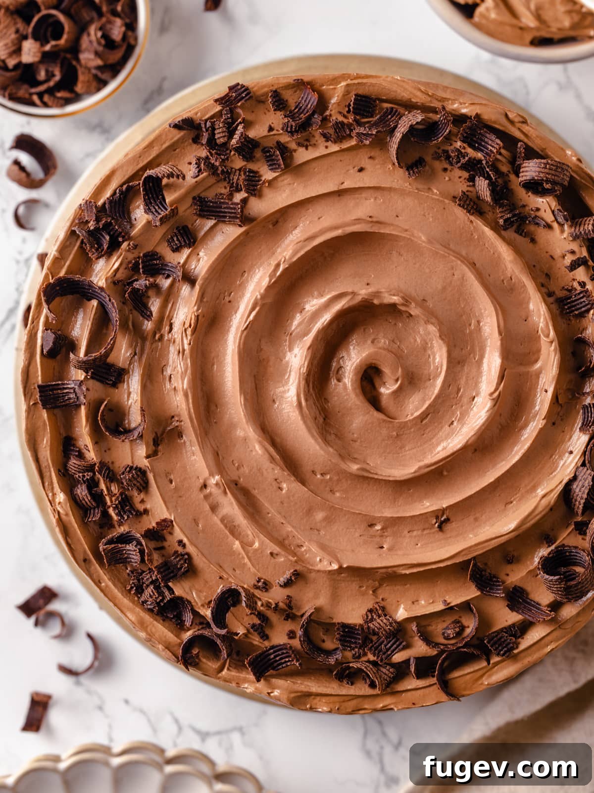 Sinfully Rich Chocolate Delight 25 The decorated Devil’s food cake, featuring elegant buttercream swirls and delicate chocolate curls for a sophisticated finish.