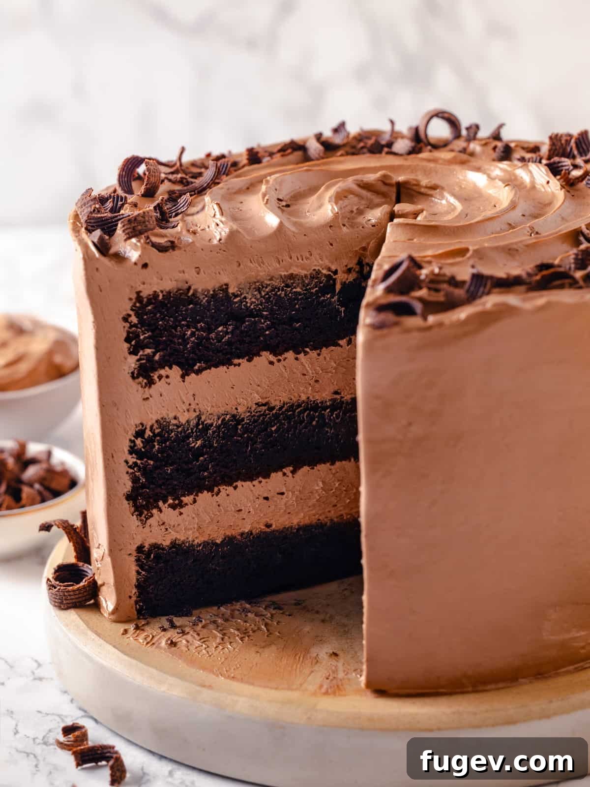 Sinfully Rich Chocolate Delight 26 Frosted chocolate cake with a missing slice, clearly showing the uniform, moist texture of the interior layers and creamy buttercream.