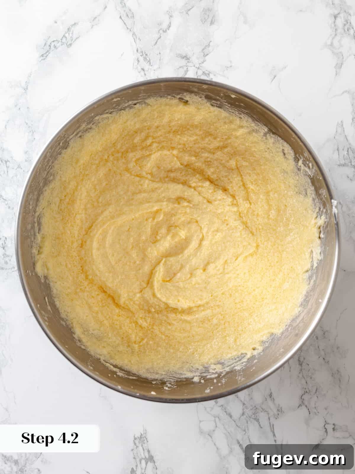 Sinfully Rich Chocolate Delight 9 Fully combined cake batter showing eggs thoroughly mixed into the creamed butter and sugar, creating a cohesive base.