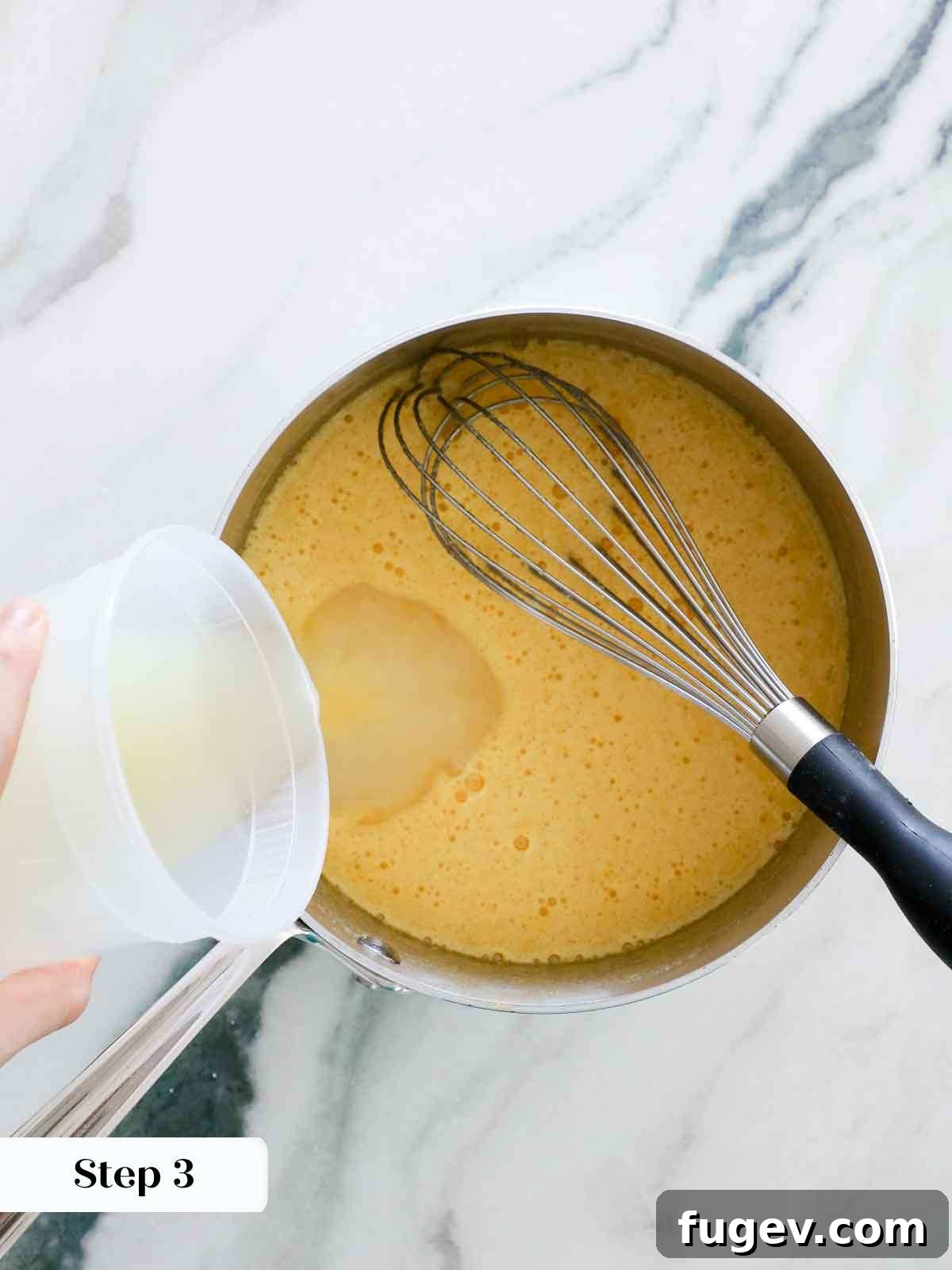 Bright & Tangy Lemon Curd 7 A bowl showing granulated sugar and salt being whisked into the previously prepared eggs, forming a pale yellow mixture.