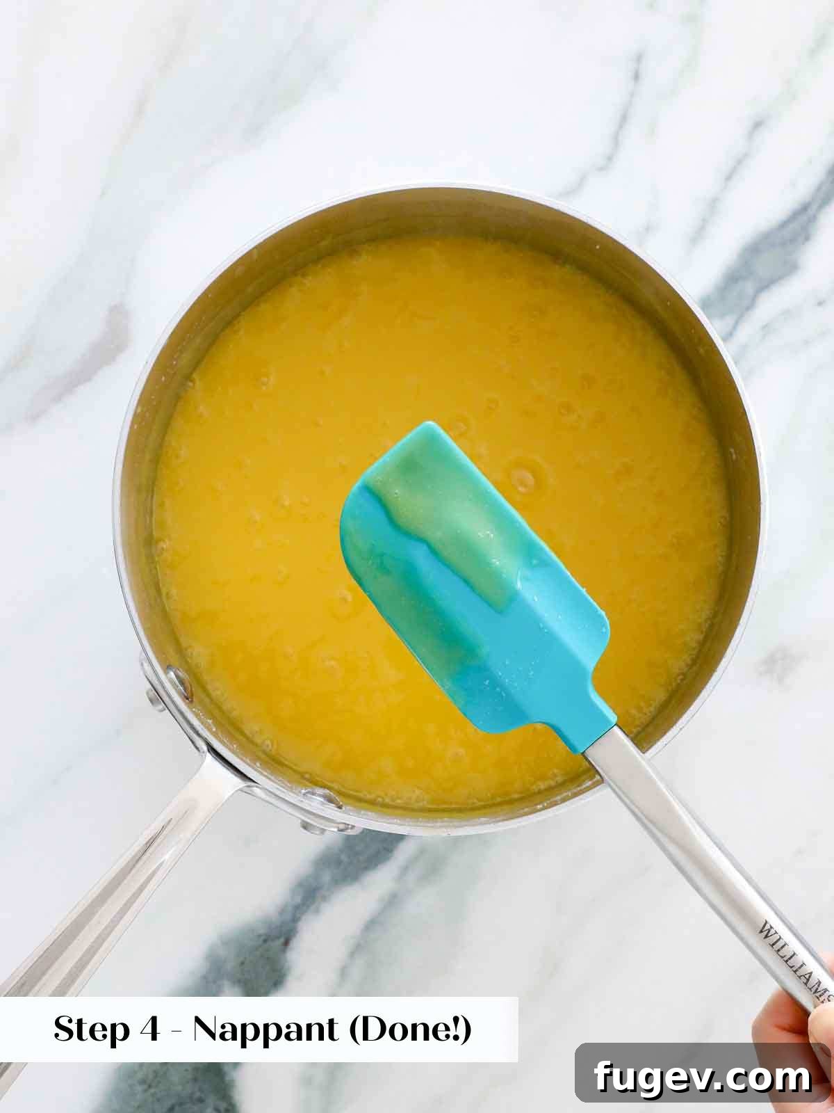 Bright & Tangy Lemon Curd 9 A spoonful of perfectly cooked lemon curd, demonstrating the 'nappant' consistency by holding a clear line drawn across its back with a finger.