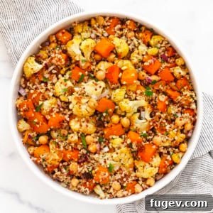 A bowl of roasted butternut squash and cauliflower quinoa, showcasing the rich colors and textures of the dish.