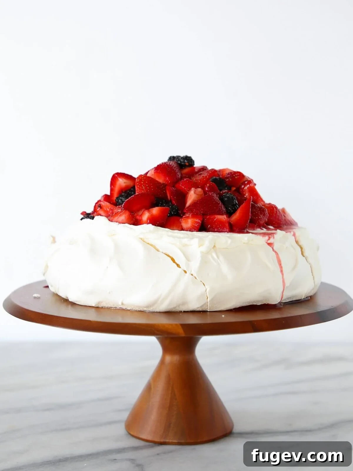 Zesty Berry Pavlova Dream 2 A majestic Lemon Berry Pavlova Cake, artfully arranged on a white backdrop, showcasing its golden-crisp edges, cloud-like interior, and generous toppings of lemon curd and brightly colored mixed berries.