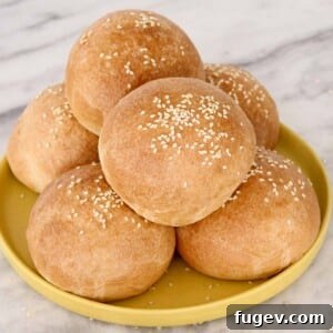 Perfect Fluffy Brioche Buns 9 stacks of brioche buns on a yellow plate, showcasing their perfect shape and golden crust.