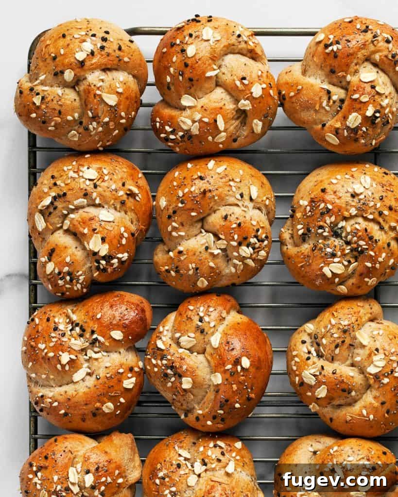 Everything Oat Twists 4 Freshly baked golden dinner rolls cooling on a wire rack