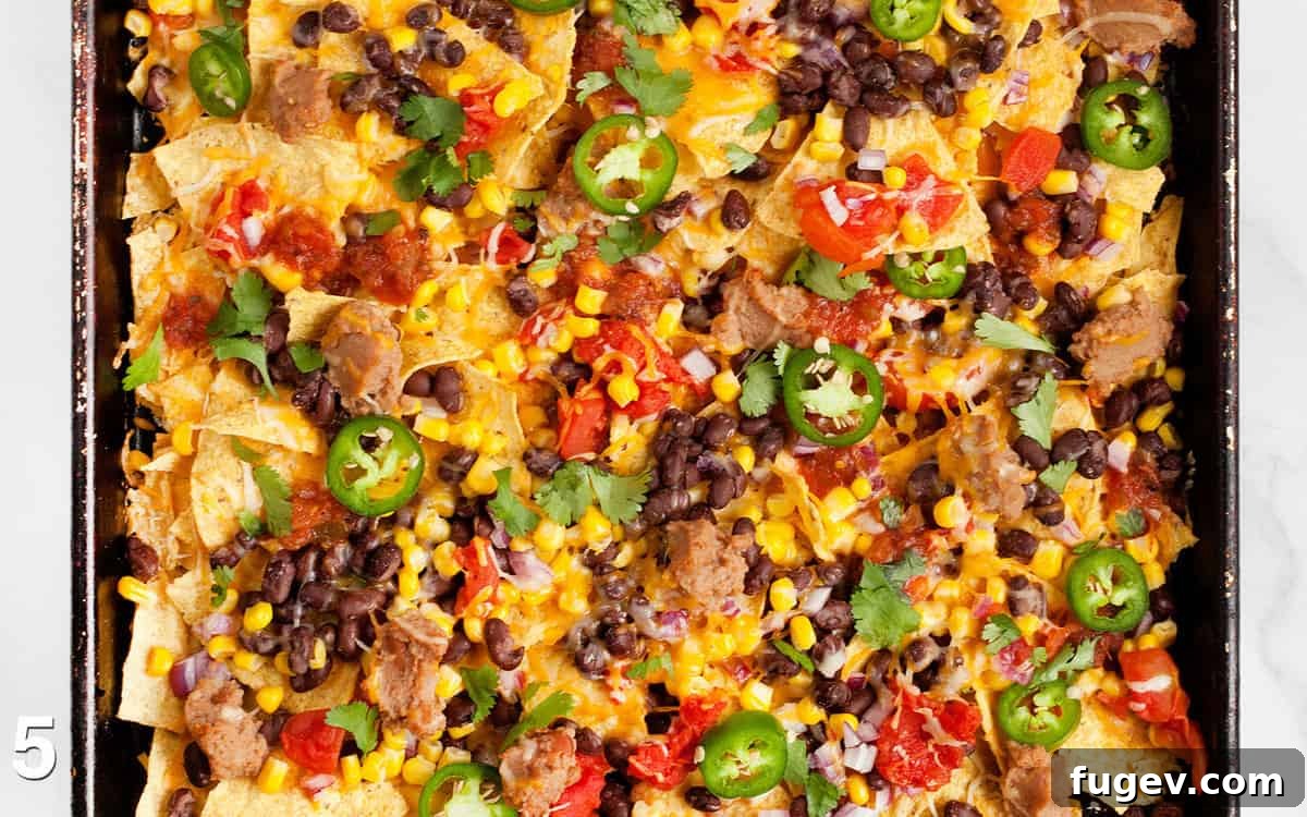 One-Pan Nacho Bake 5 Assembled nachos on a sheet pan.