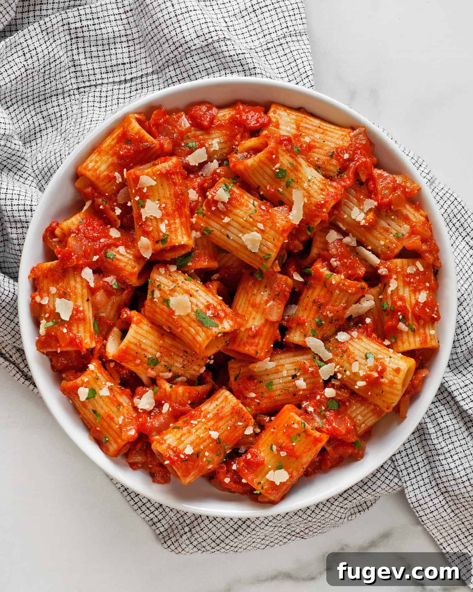 Hearty Rigatoni in Rustic Tomato Sauce 2 Delicious Rigatoni noodles generously coated in rich, homemade tomato sauce, ready to be served.