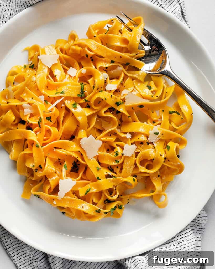 Vibrant Carrot Pasta 3 Close-up of freshly made orange carrot pasta noodles before cooking.