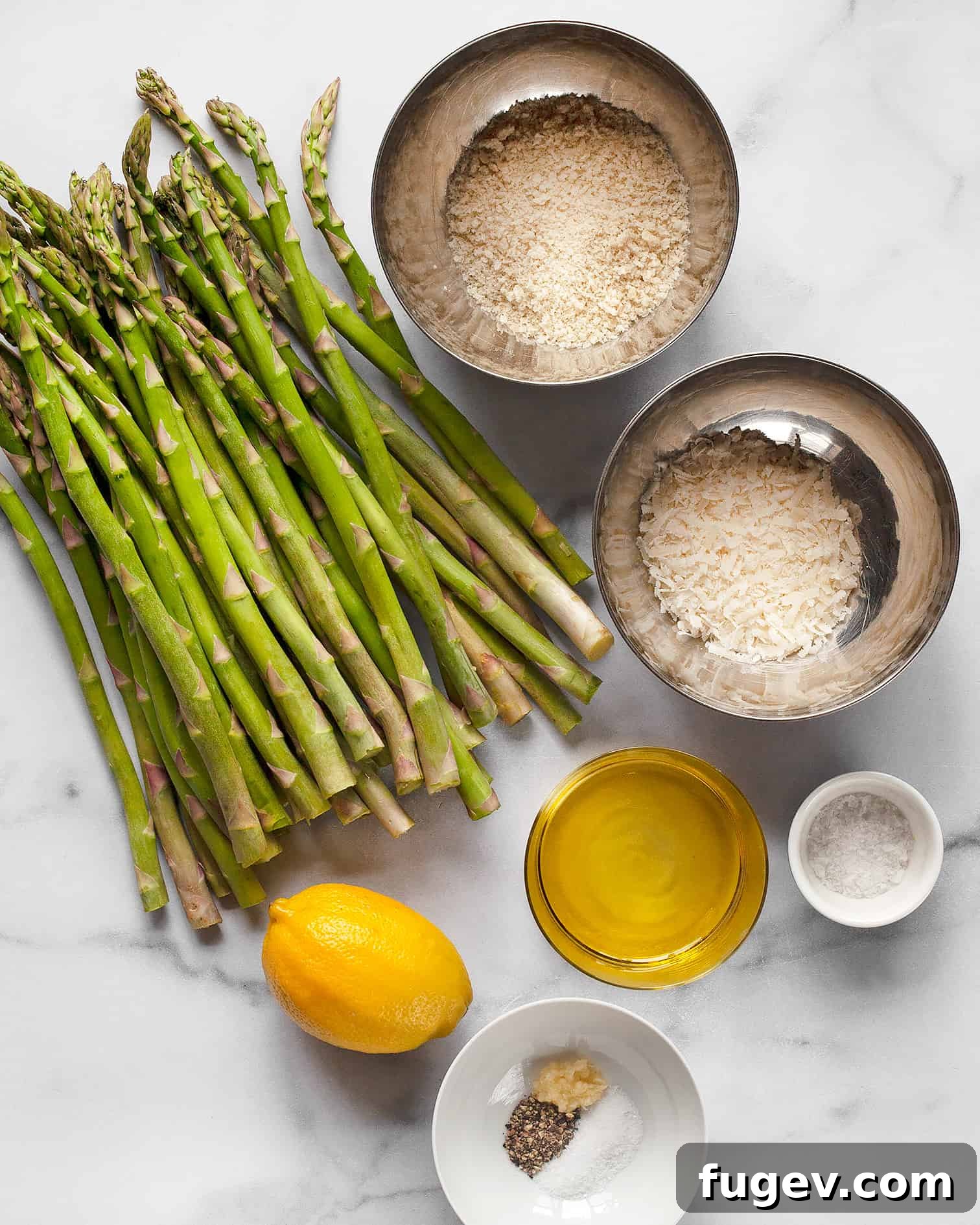 Savory Garlic Parmesan Asparagus 3 Ingredients for roasted asparagus including fresh asparagus, lemon, garlic, olive oil, panko breadcrumbs, and Parmesan cheese.