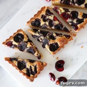 Cherry Almond Tart on marble board, a professional food photography shot.