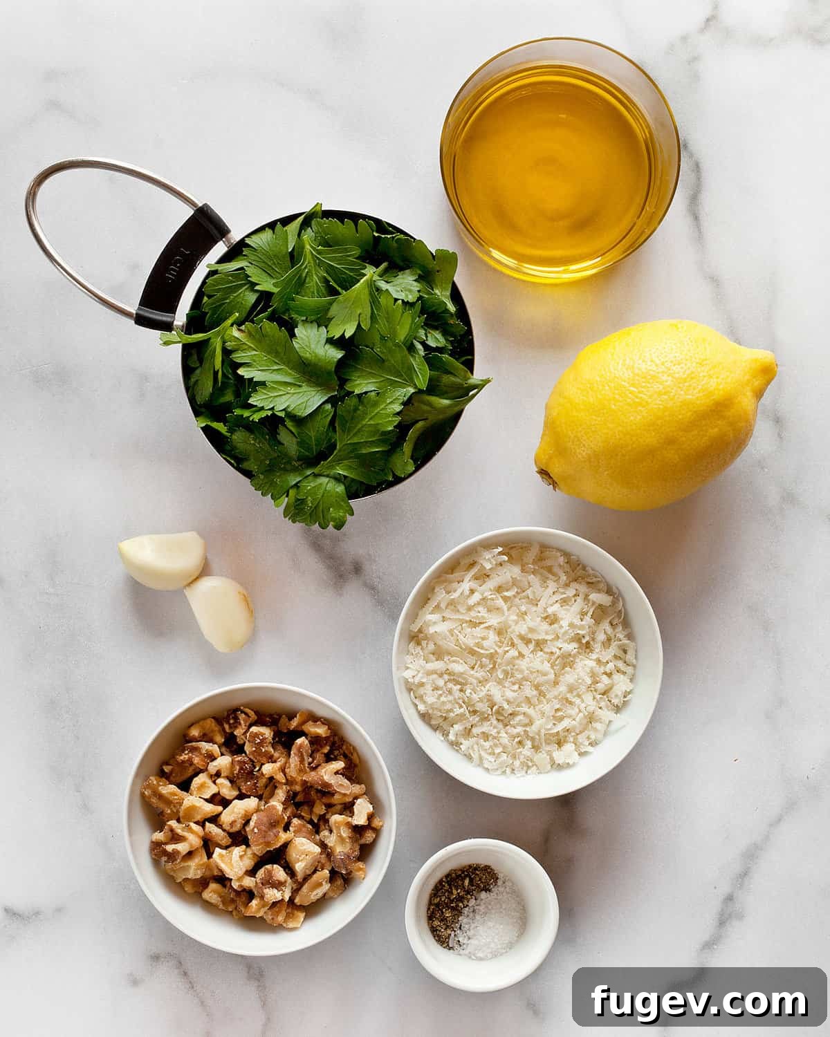 Emerald Pesto Pasta 3 A selection of fresh ingredients for parsley pesto: Italian parsley, Parmesan cheese, walnuts, lemon, garlic, olive oil, salt, and pepper.