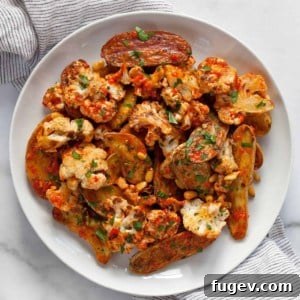 Golden Roasted Cauliflower & Potato Salad 7 Roasted cauliflower potato salad with red pepper vinaigrette on a plate