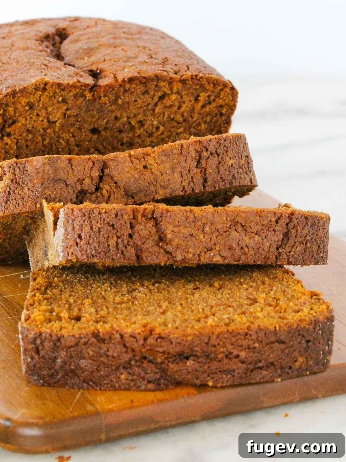 Spiced Pumpkin Delight 11 A tantalizing close-up of freshly sliced pumpkin bread, showcasing its incredibly moist, tender texture and rich color.