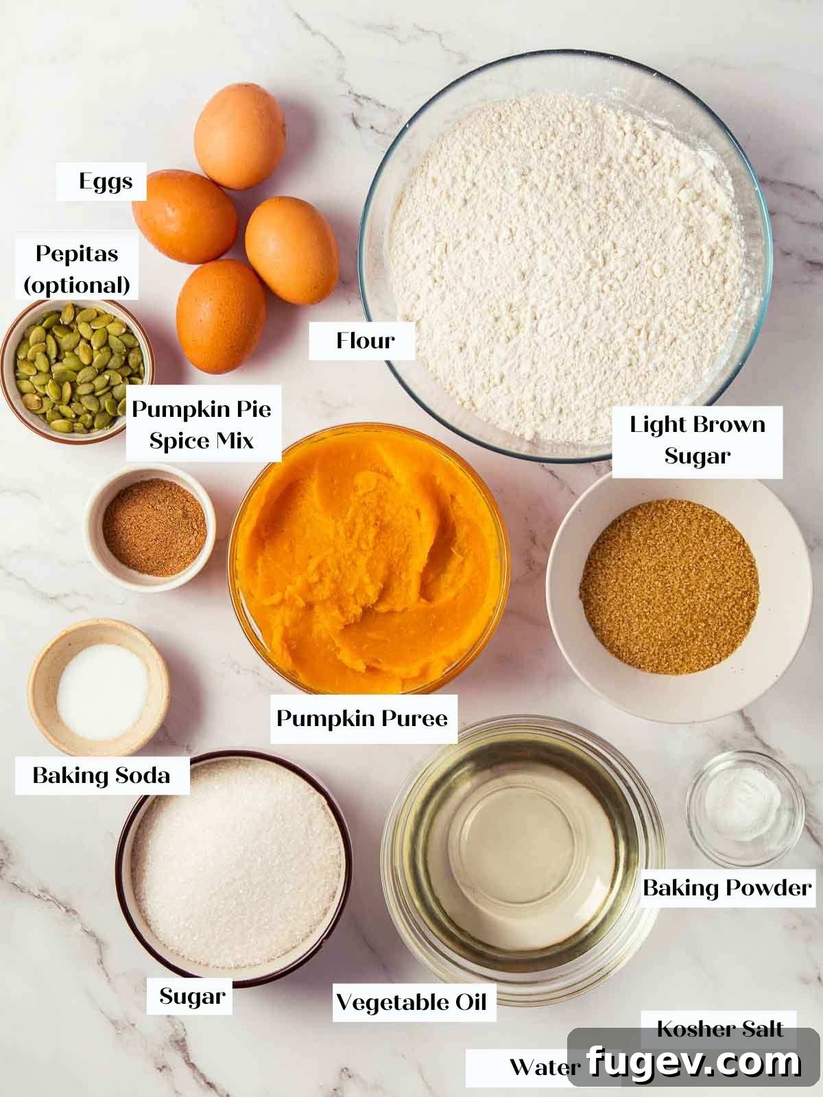 Spiced Pumpkin Delight 4 A perfectly arranged selection of pumpkin bread ingredients on a pristine white marble countertop, ready for baking.