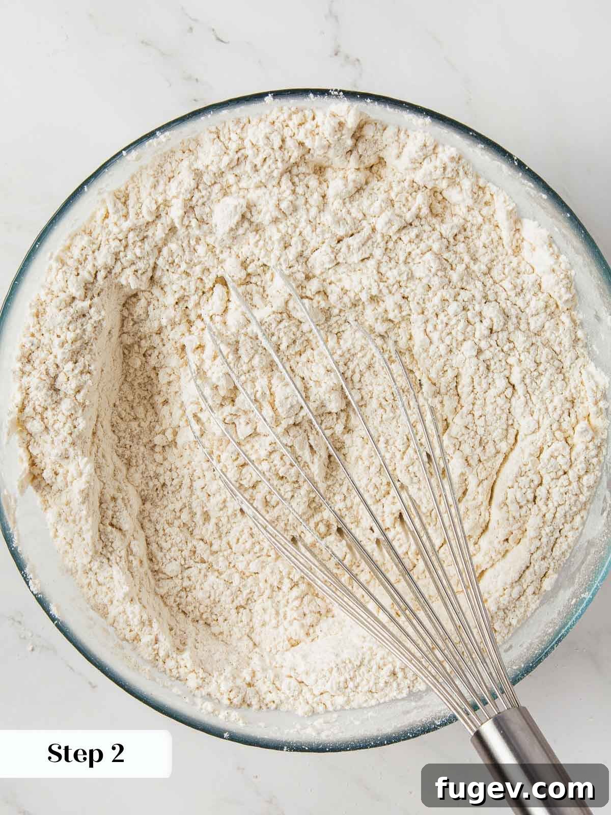 Spiced Pumpkin Delight 6 Dry ingredients for pumpkin bread being meticulously whisked together in a bowl, ensuring even distribution of spices and leavening agents.
