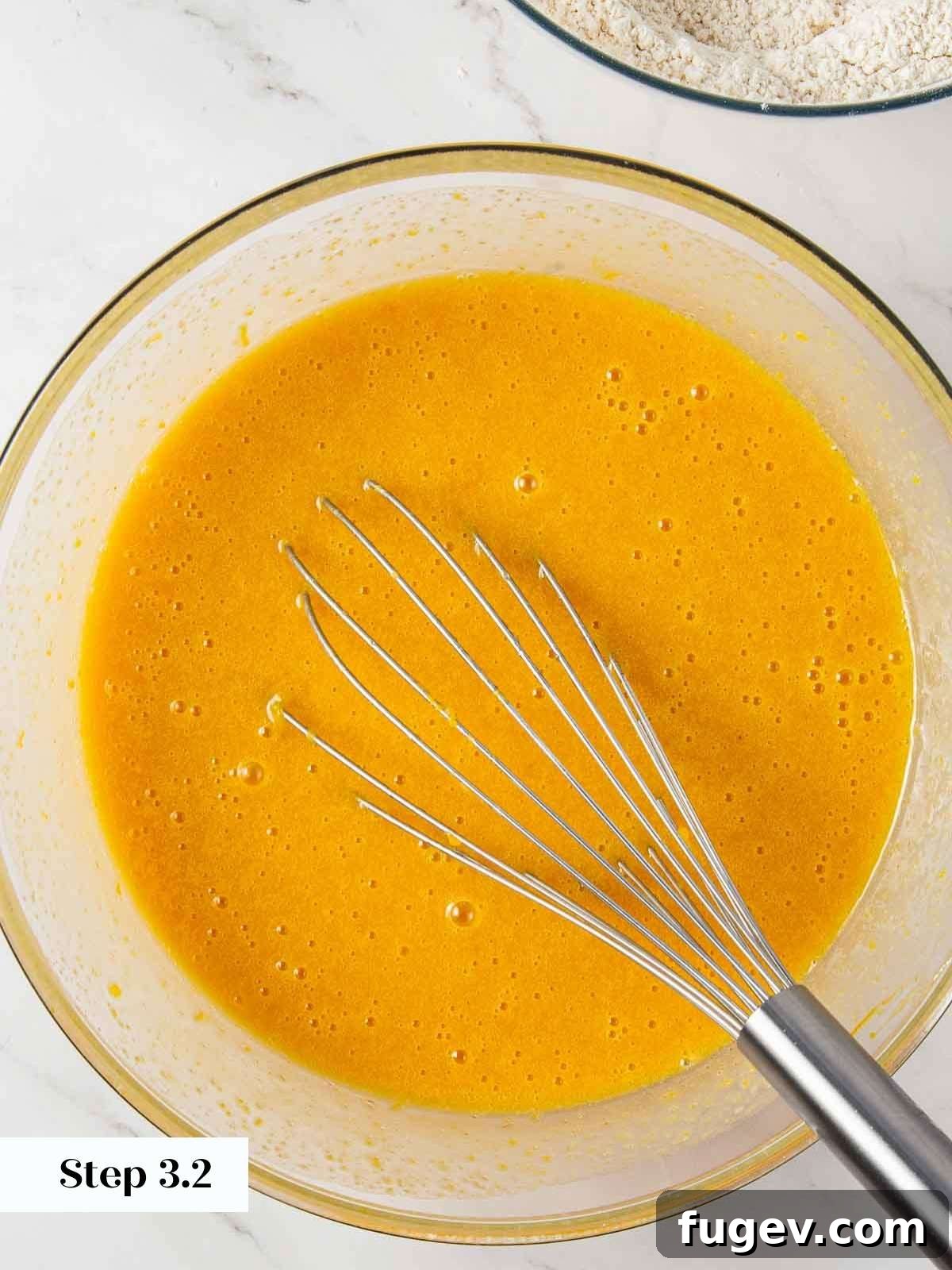 Spiced Pumpkin Delight 8 The wet ingredients for pumpkin bread, including pumpkin puree and oils, are fully combined and emulsified into a smooth, luscious mixture.