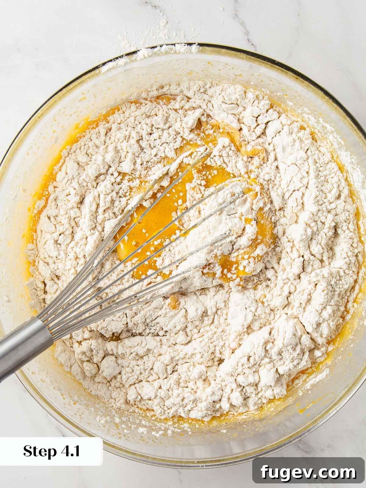 Spiced Pumpkin Delight 9 The process of gently folding wet and dry ingredients together for pumpkin bread, emphasizing minimal mixing.