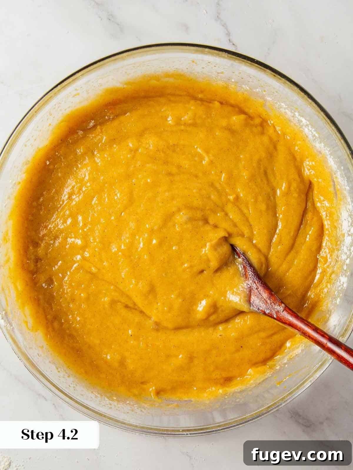 Spiced Pumpkin Delight 10 A close-up of smooth and creamy pumpkin bread batter, perfectly mixed and ready to be poured into loaf pans.